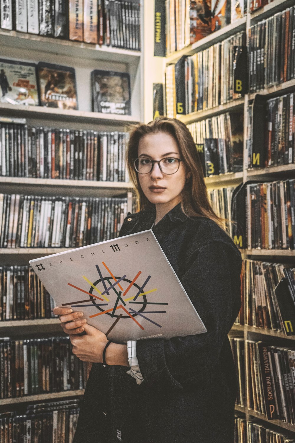 woman in black long sleeve shirt holding book