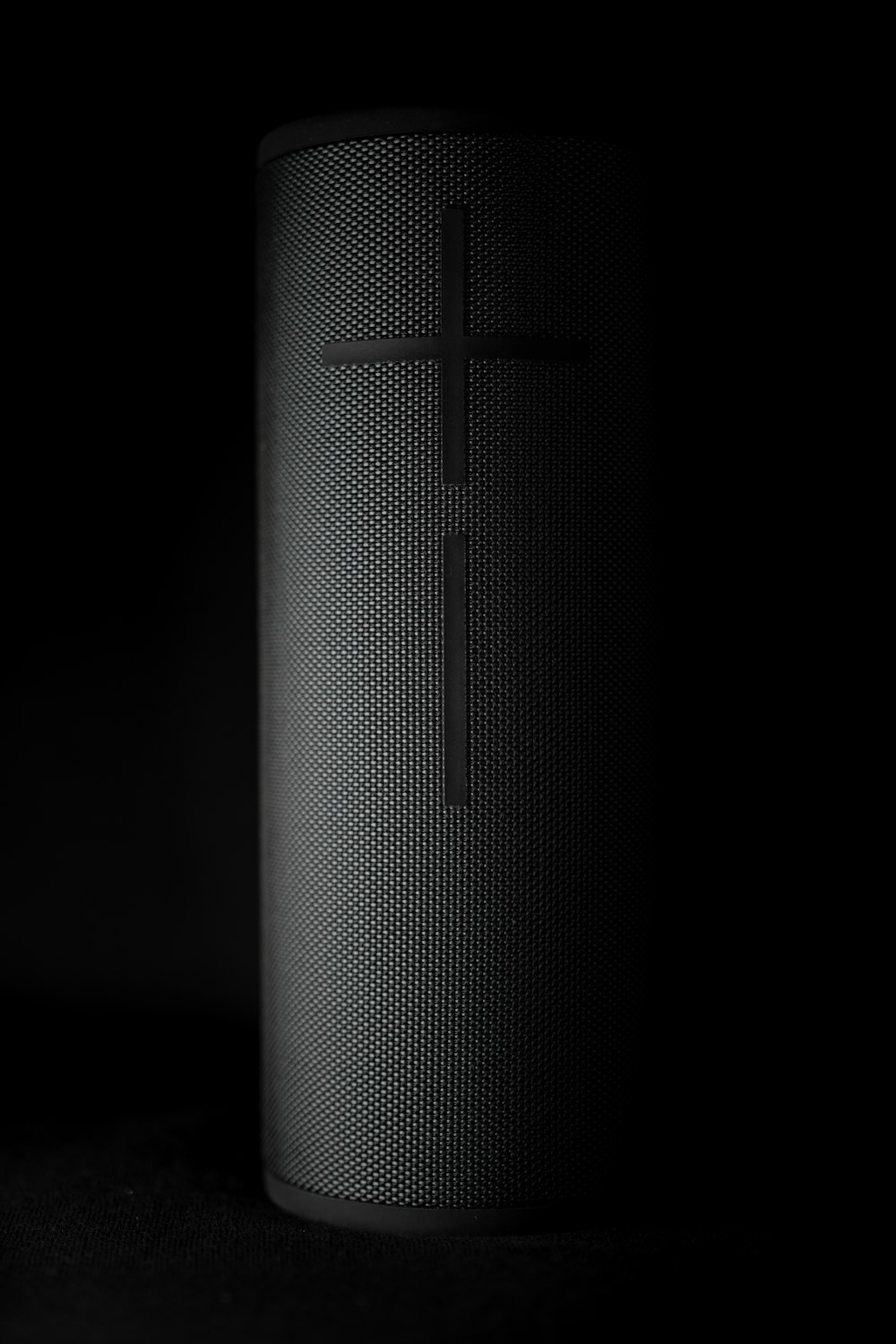 a black speaker with a cross on it