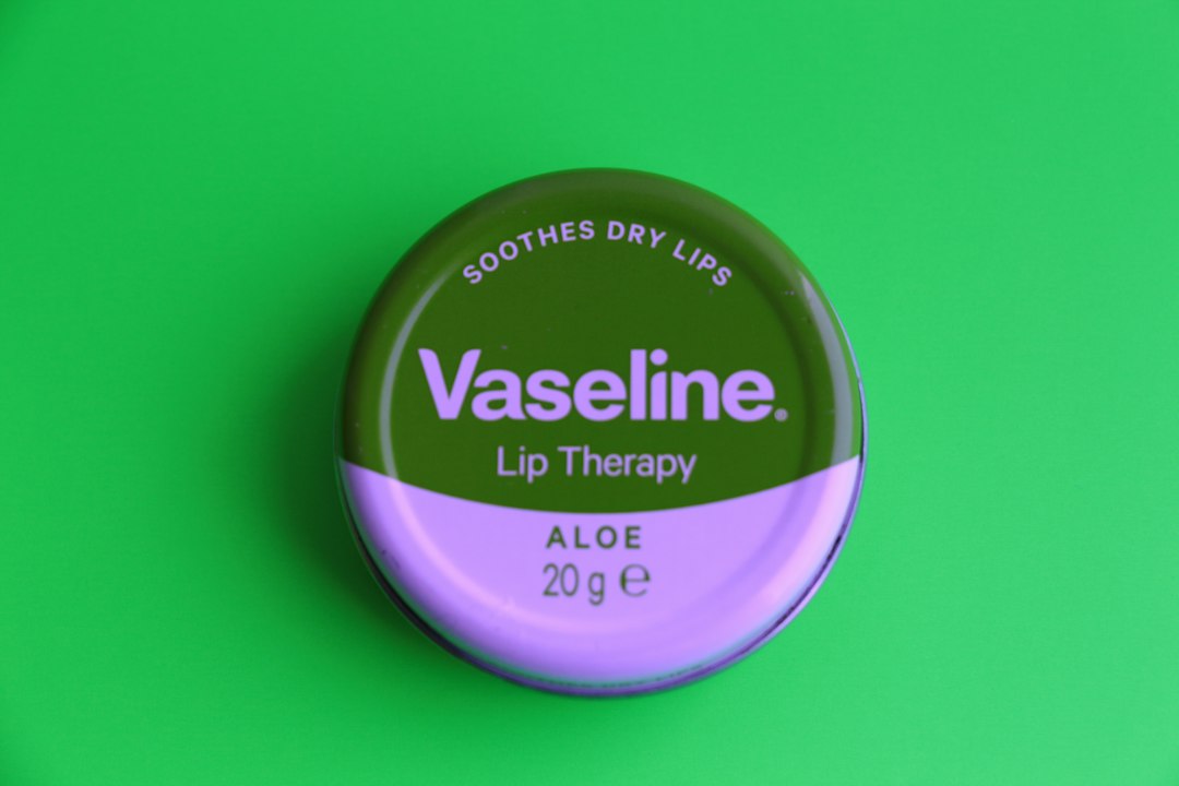 nivea creme on green surface, Aloe Vaseline lip therapy.