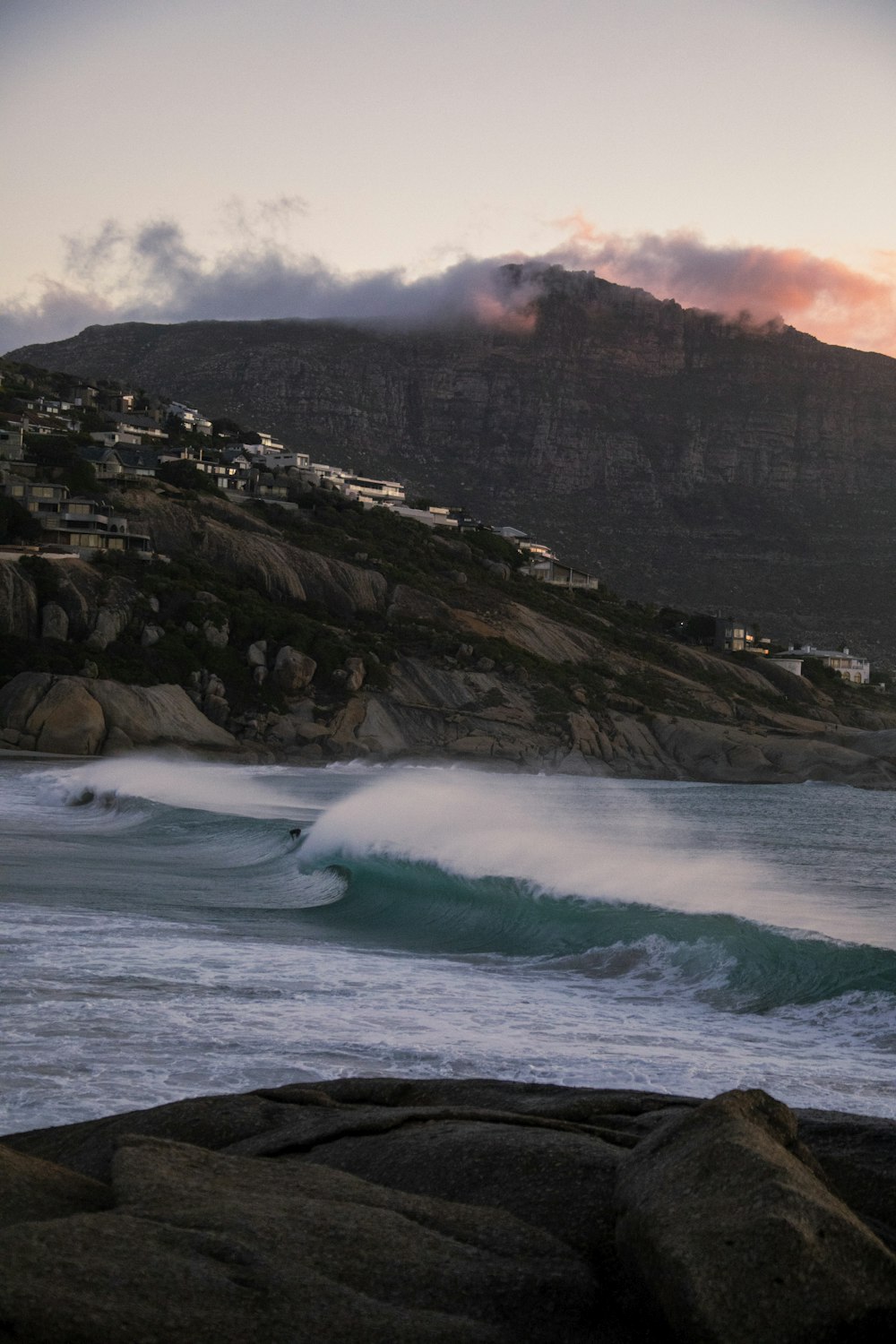 ocean waves crashing on rocky shore during daytime