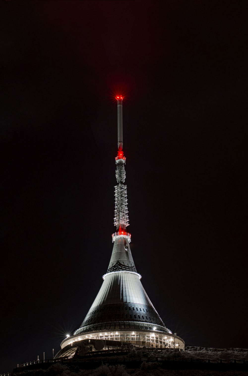 a very tall tower with a red light on top of it