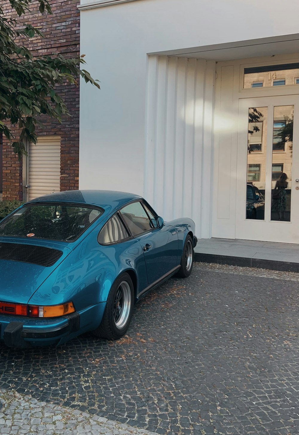 a blue car parked in front of a building