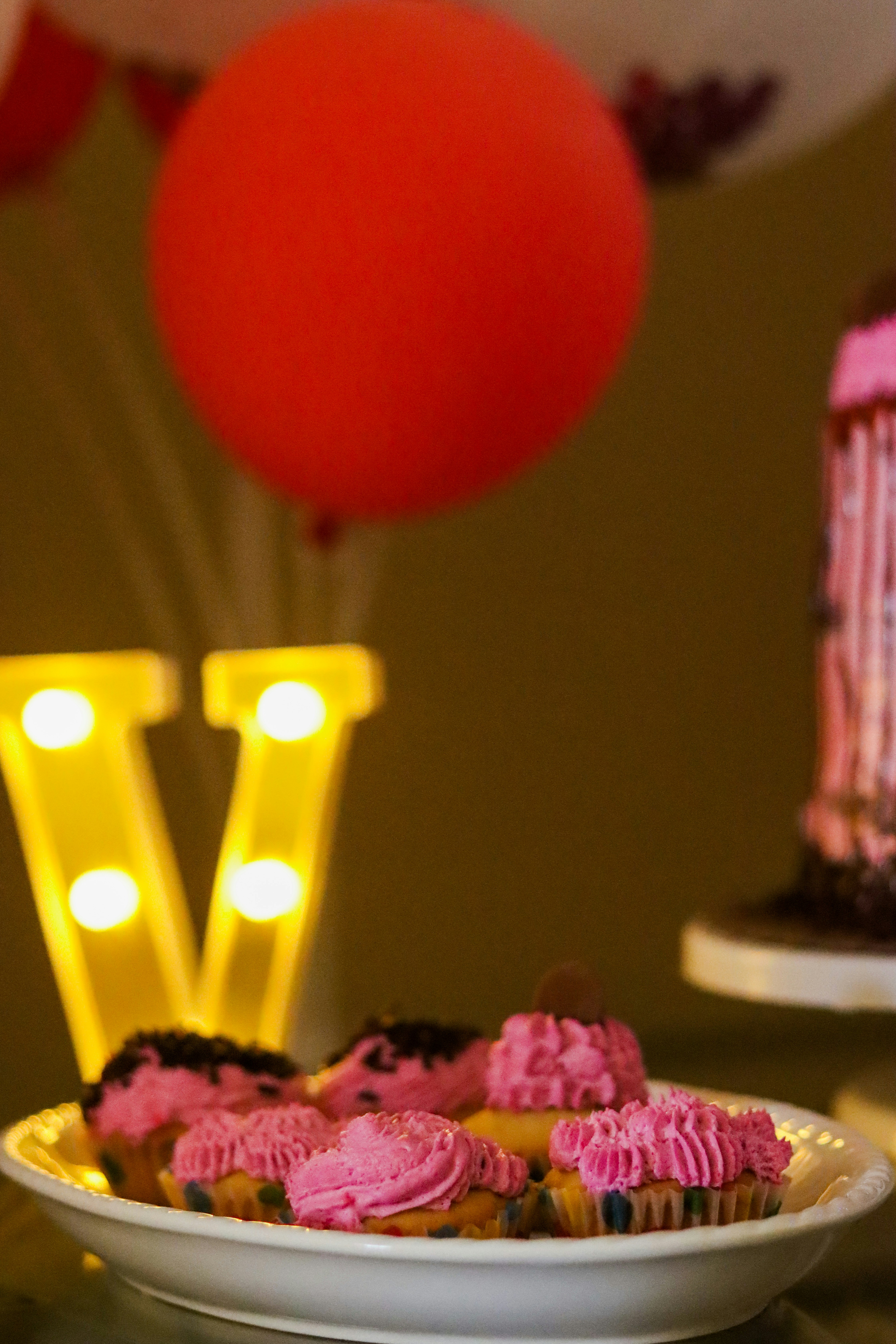Custom cupcake toppers with Amahle name and age 5 in pink Barbie theme in bright light