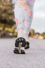 Close-up of a runner wearing breathable knee and ankle supports on a trail.