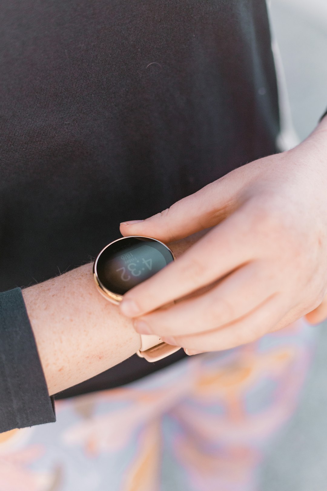 person wearing black and silver ring