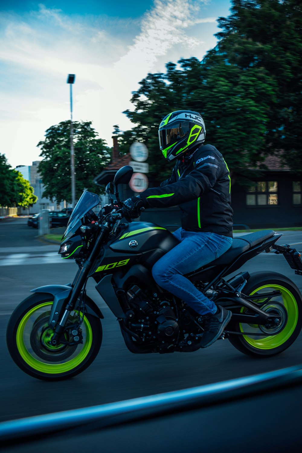 man in black jacket riding on motorcycle during daytime