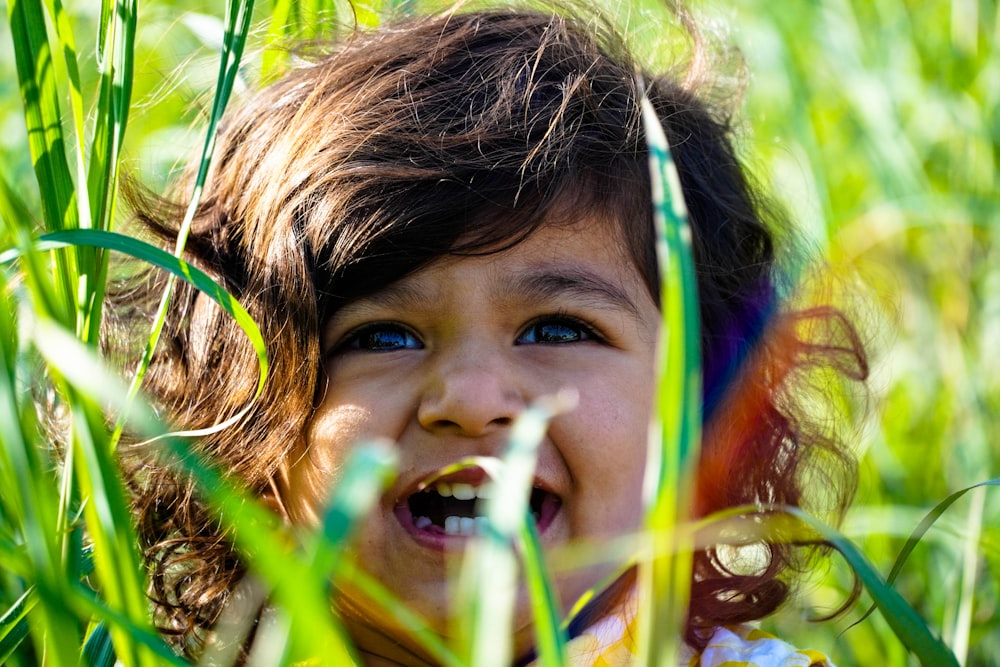 girl with brown hair lying on grass