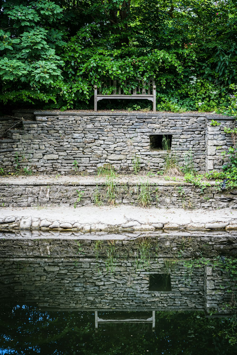 brown brick house near river during daytime