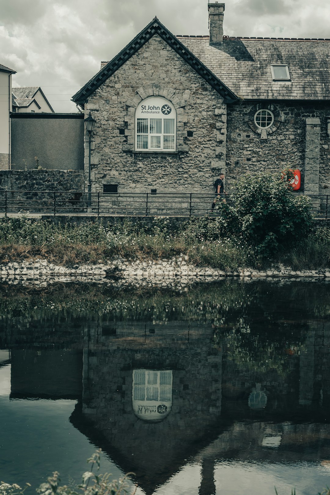 gray concrete house beside river during daytime