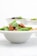 A bowl filled with fresh basil leaves, dollops of creamy white sauce, and a rich red tomato-based sauce, possibly pasta or a similar dish. The focus is on the vibrant colors and textures of the ingredients.