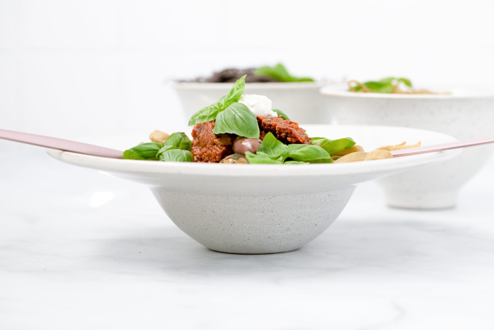 white ceramic bowl with green and brown dish