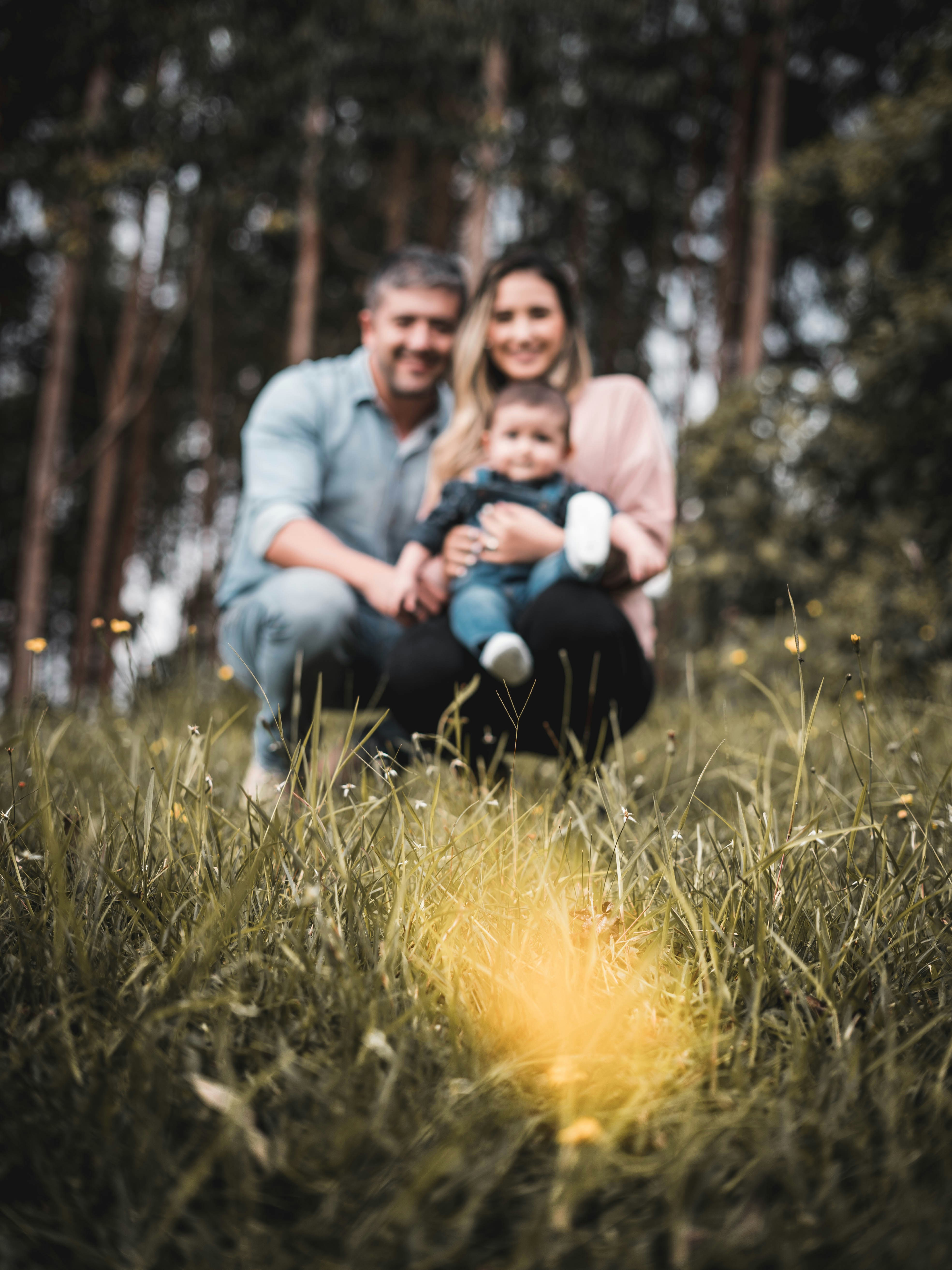man and woman sitting on green grass field during daytime