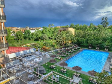 A serene hotel garden area with greenery and seating for relaxation.