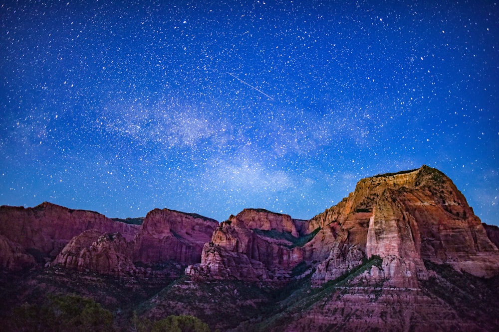 brown rocky mountain under blue sky