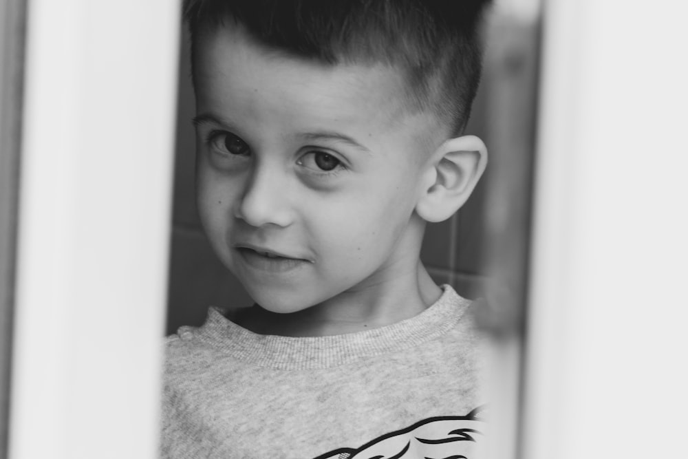 grayscale photo of boy in crew neck shirt