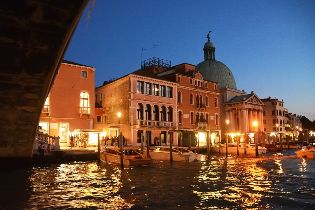 boat on river near building during night time