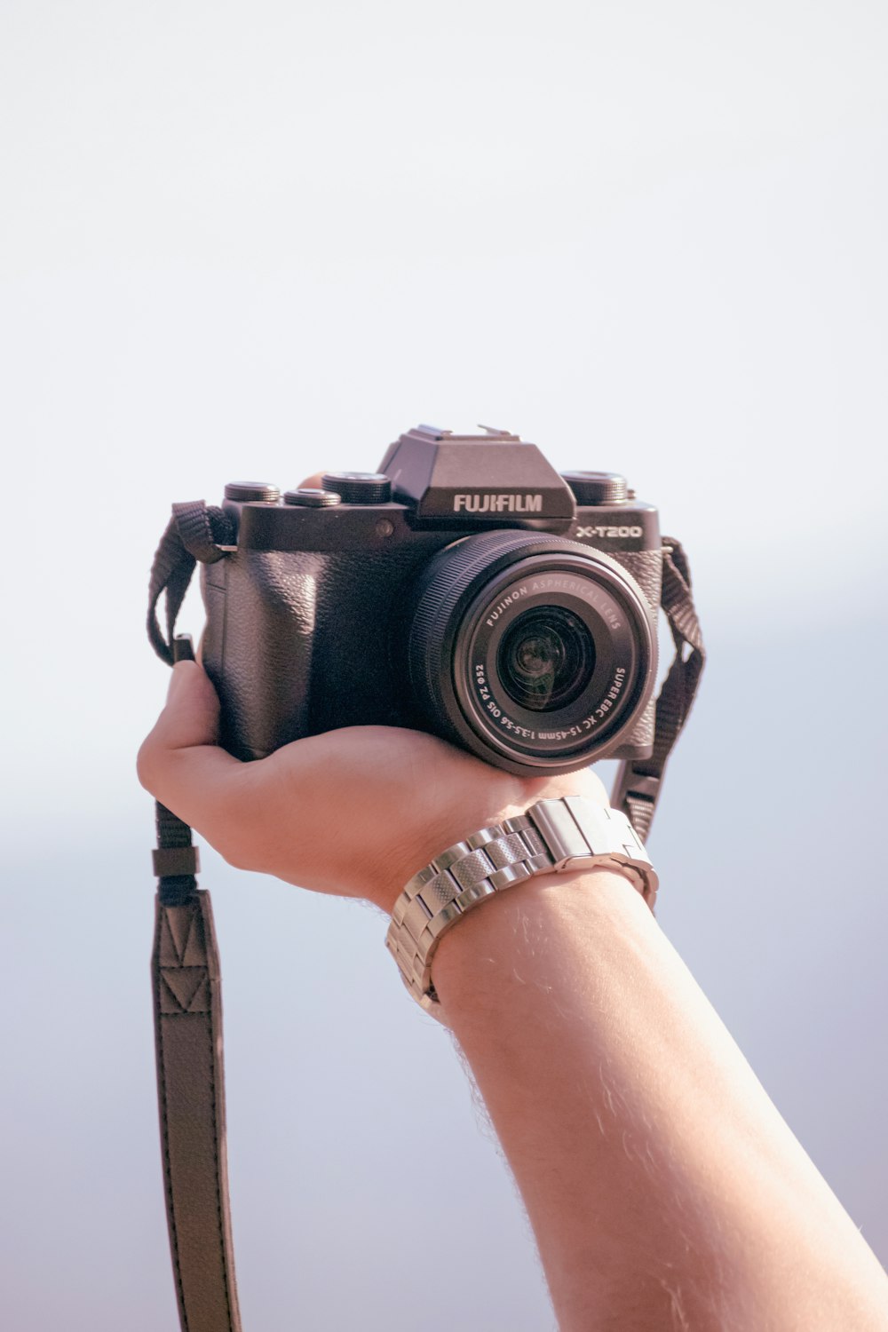 person holding black nikon dslr camera