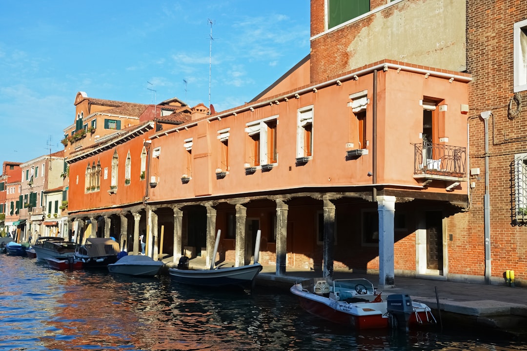 boat on river near brown concrete building during daytime