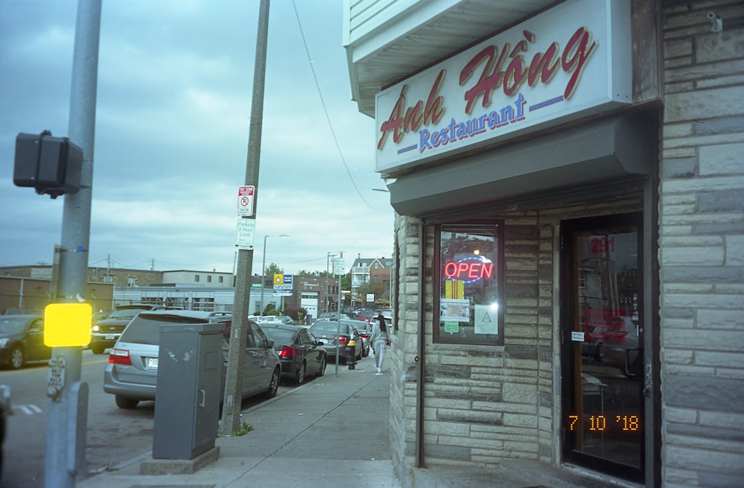 white car parked beside store during daytime