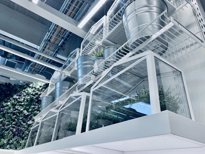 Stacked corner steel cabinets in a bright, airy room with plants nearby.