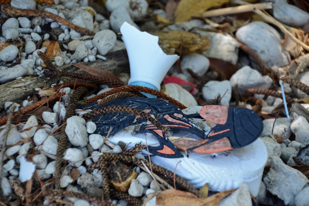 white plastic bottle on white and brown stones