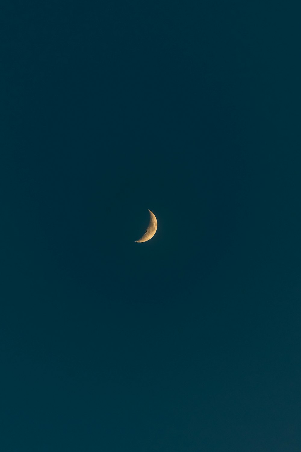 white crescent moon in blue sky