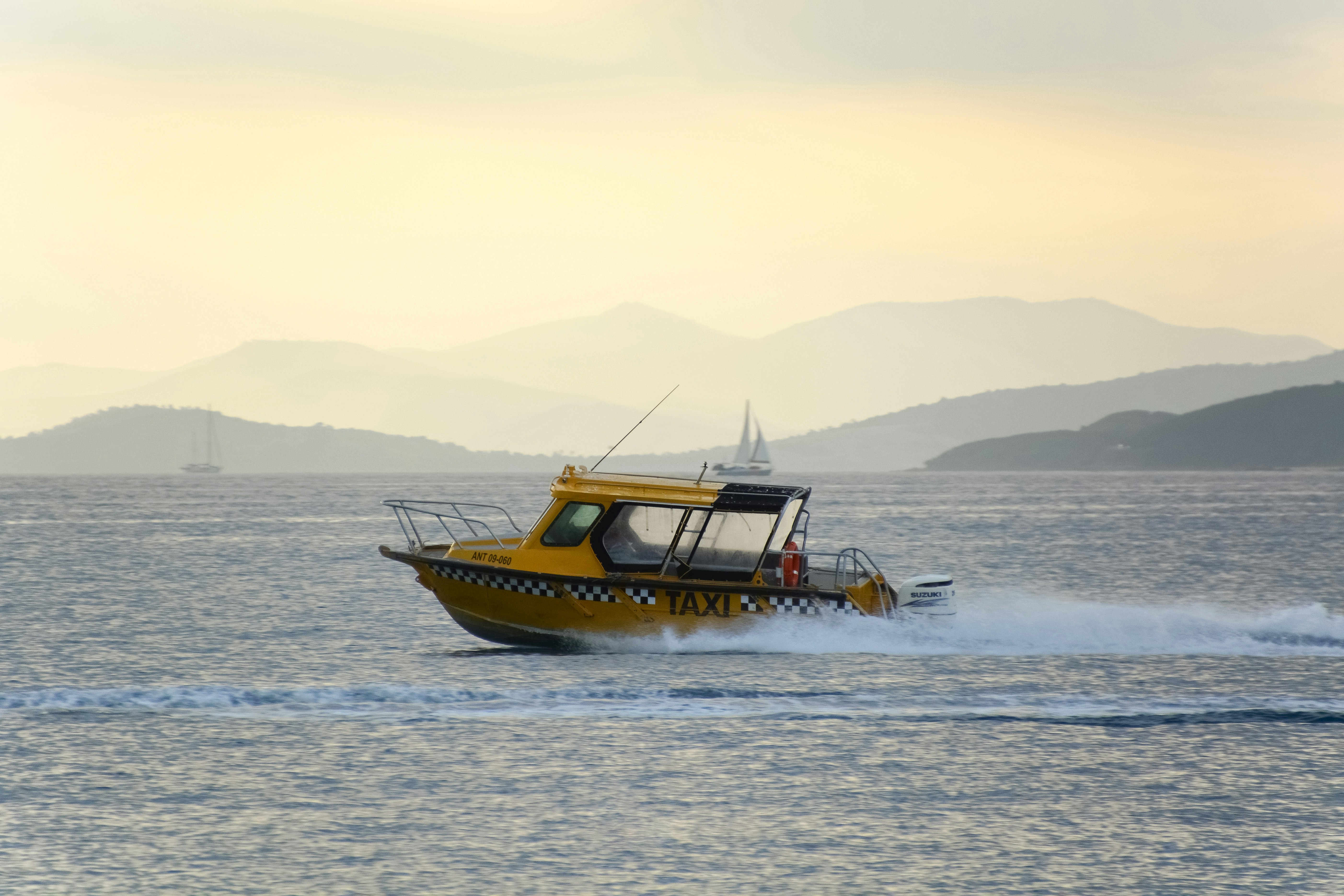 yellow and black boat on sea during daytime