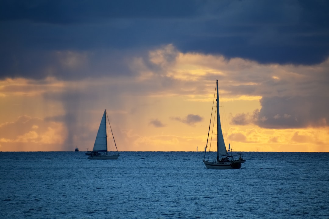 silhouette of sailboat on sea during sunset