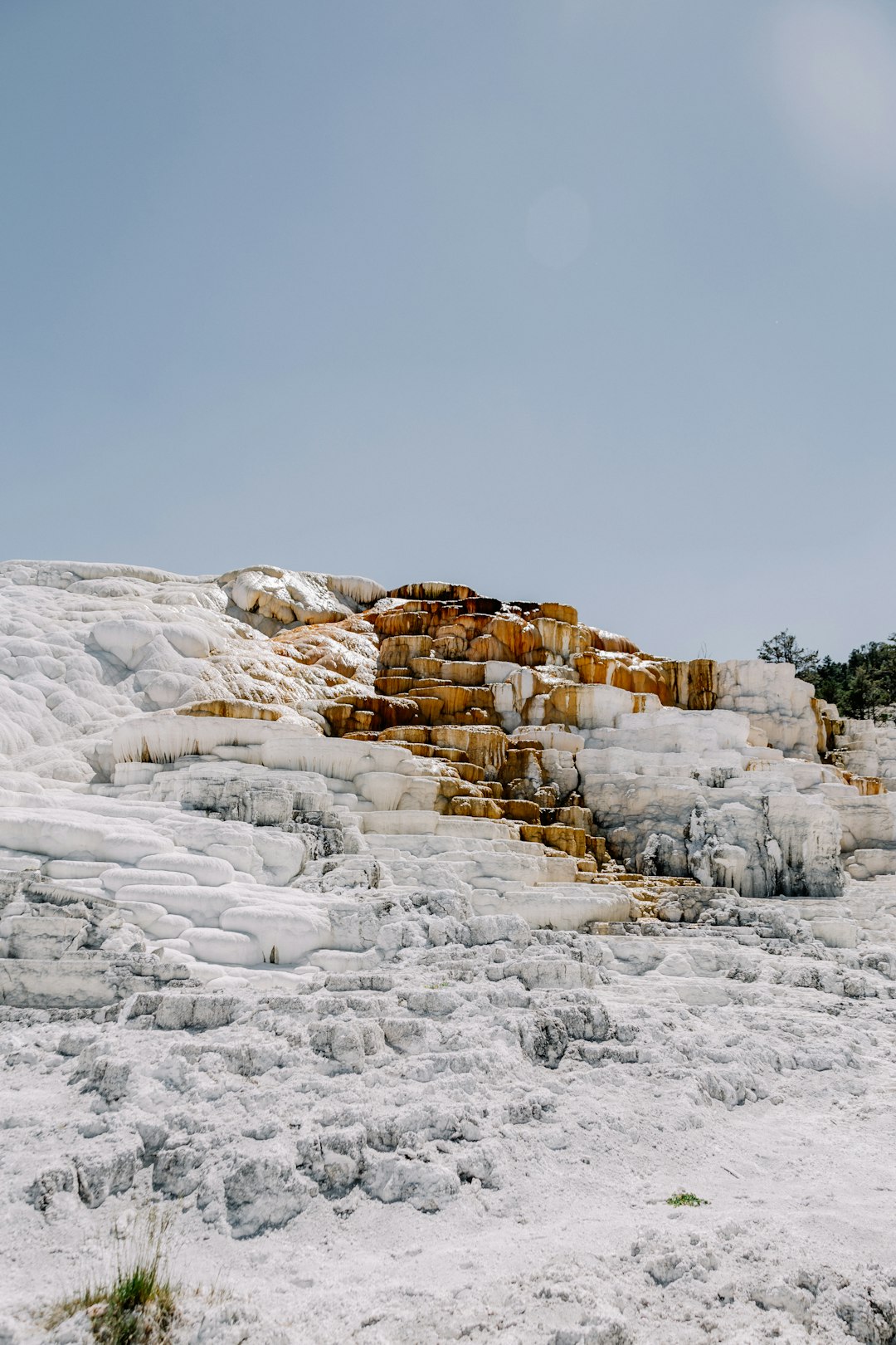 brown rocky mountain covered by snow during daytime