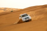 white suv on brown sand
