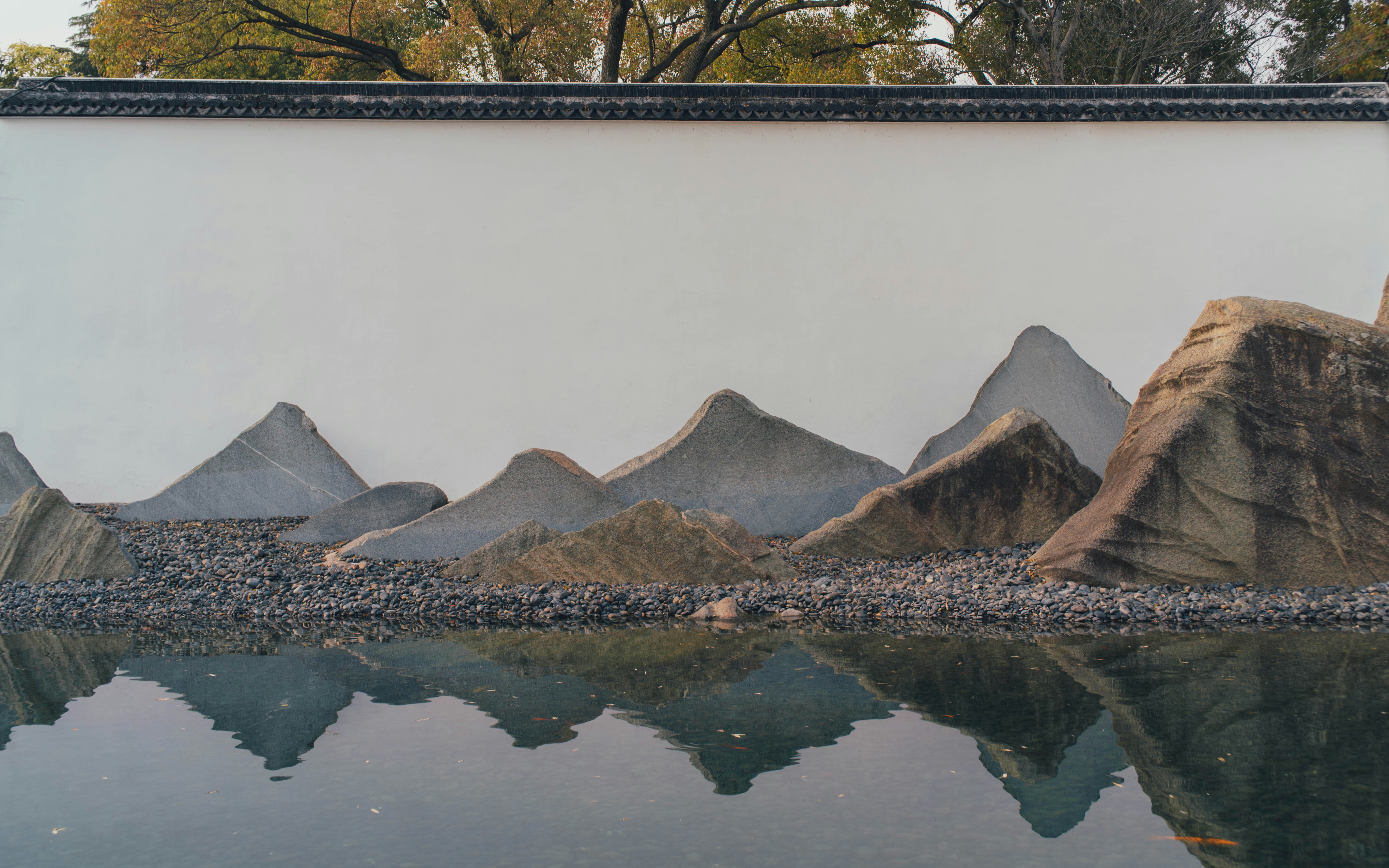 brown and white mountain near body of water during daytime