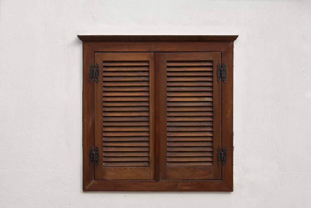 puerta de madera marrón sobre pared blanca