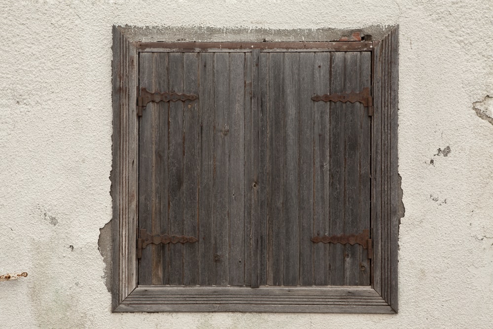 brown wooden door on white wall