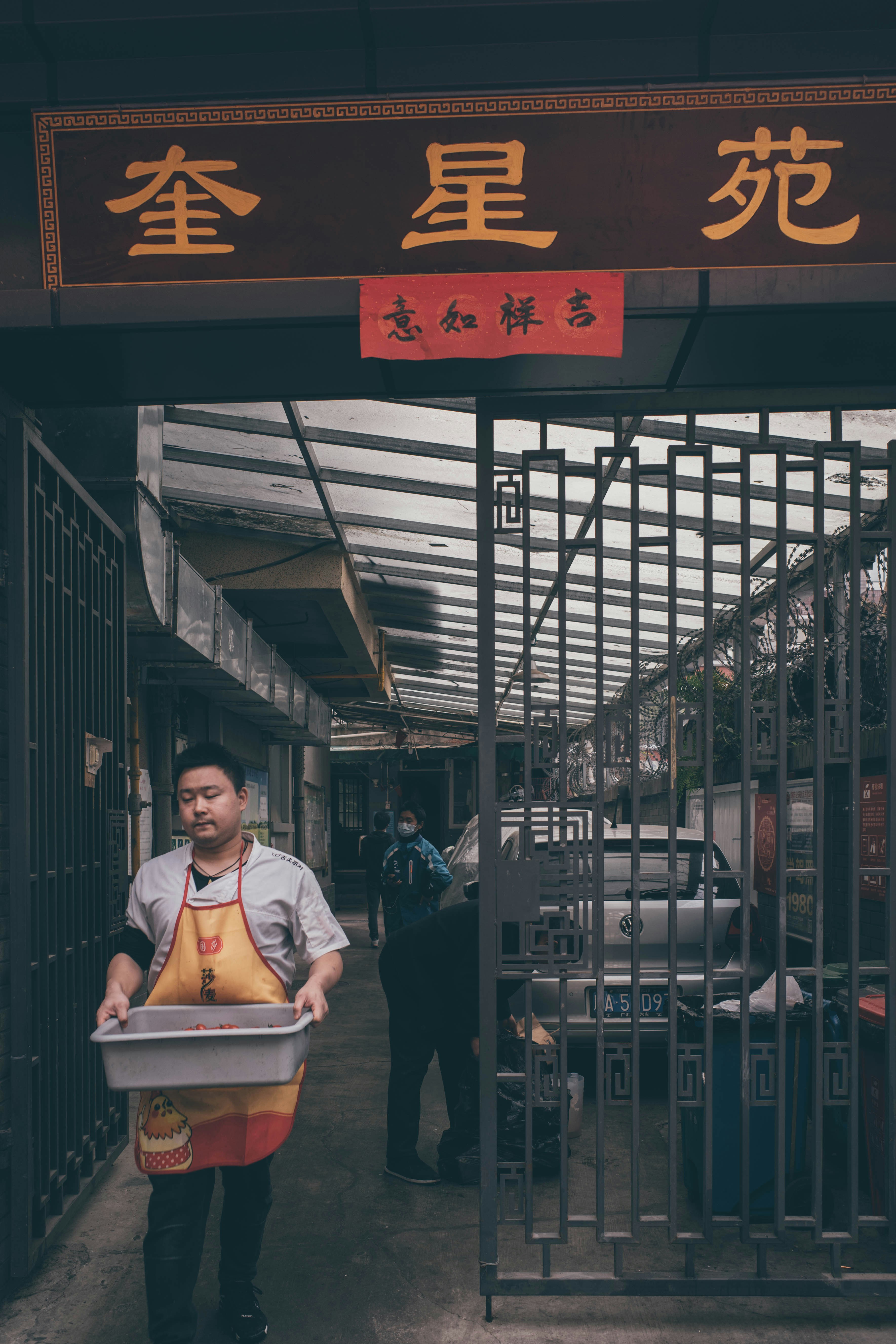 man in white dress shirt and blue denim jeans sitting on chair