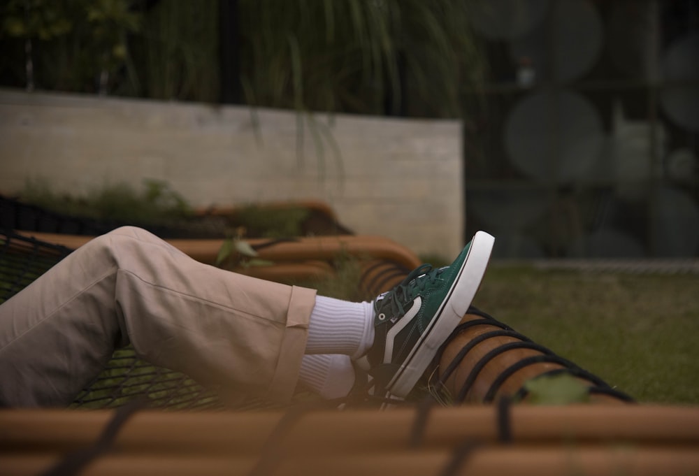 person in gray pants wearing black and white nike sneakers