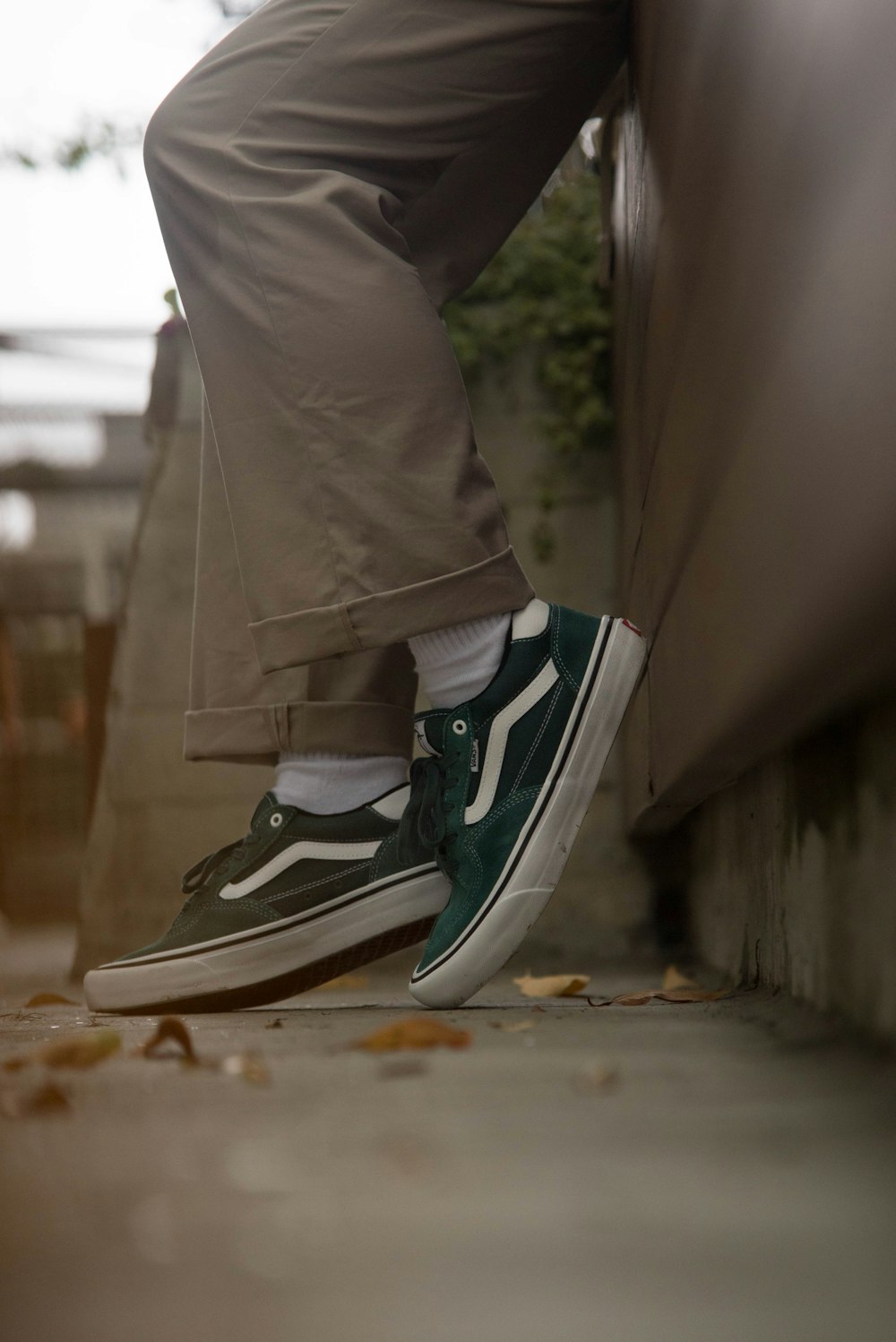 person in gray pants wearing black and white nike sneakers