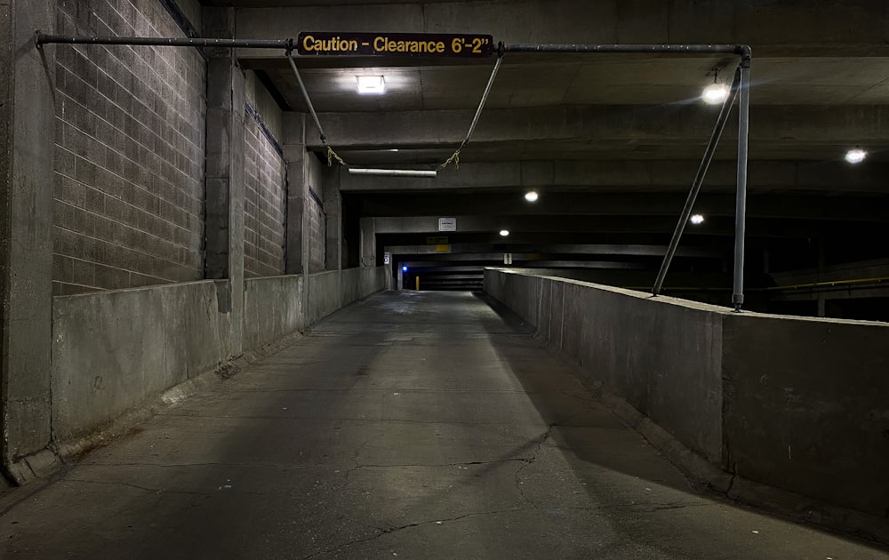 gray concrete tunnel with yellow lights