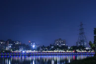 Nighttime cityscape illuminated by reliable power infrastructure, reflecting community transformation.