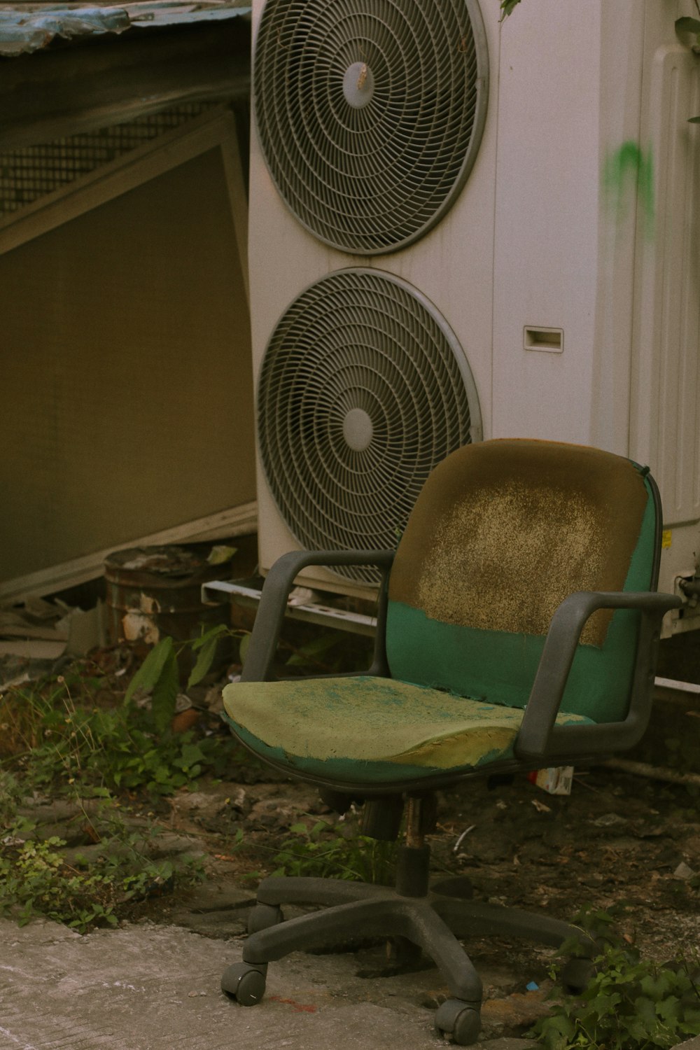 green and black chair beside white fan