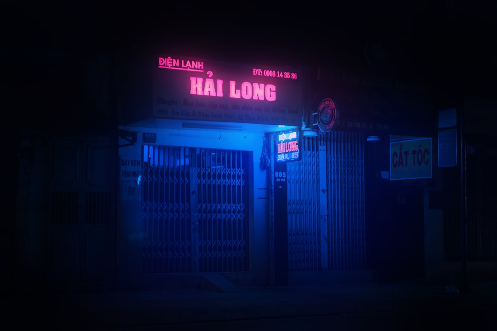 a building with a neon sign that reads hai long