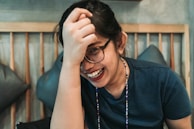 woman in black framed eyeglasses and black sleeveless shirt