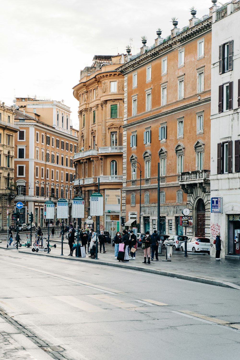 people walking on sidewalk near building during daytime