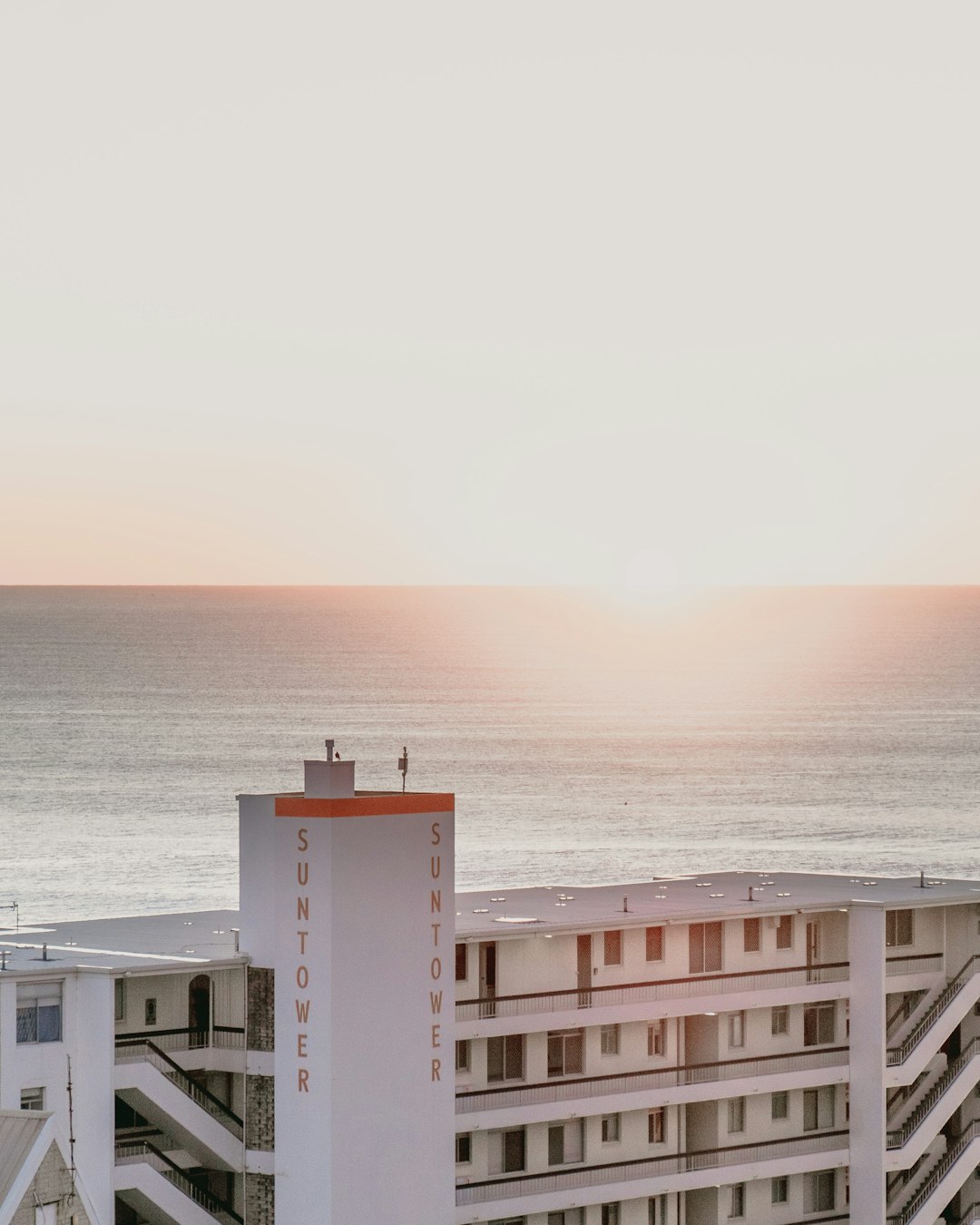 white concrete building near sea during daytime