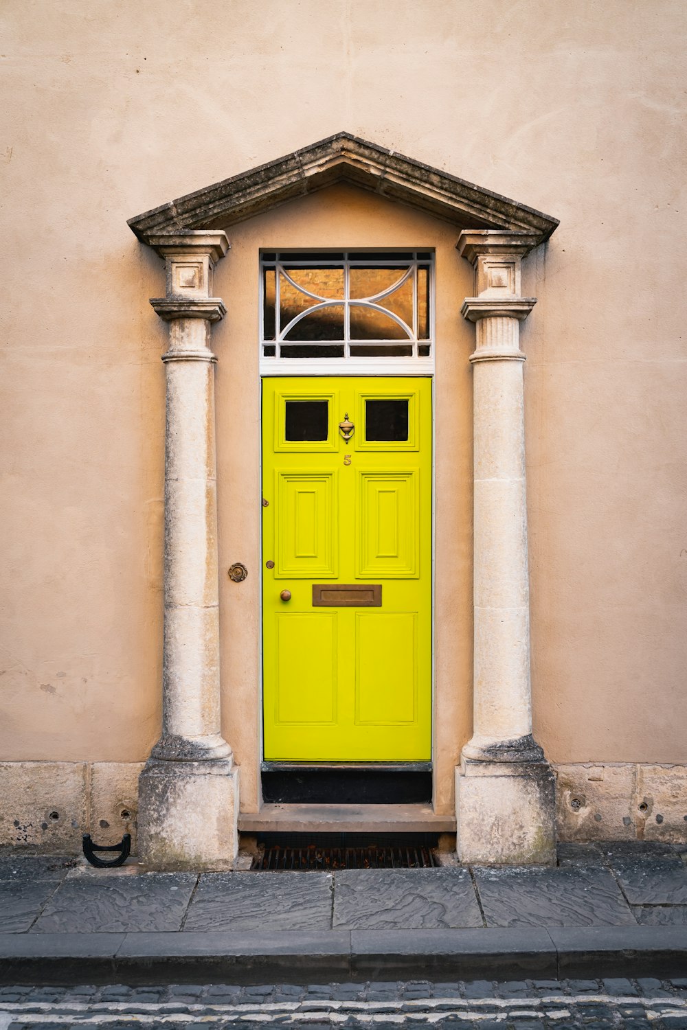 yellow wooden door on white concrete building