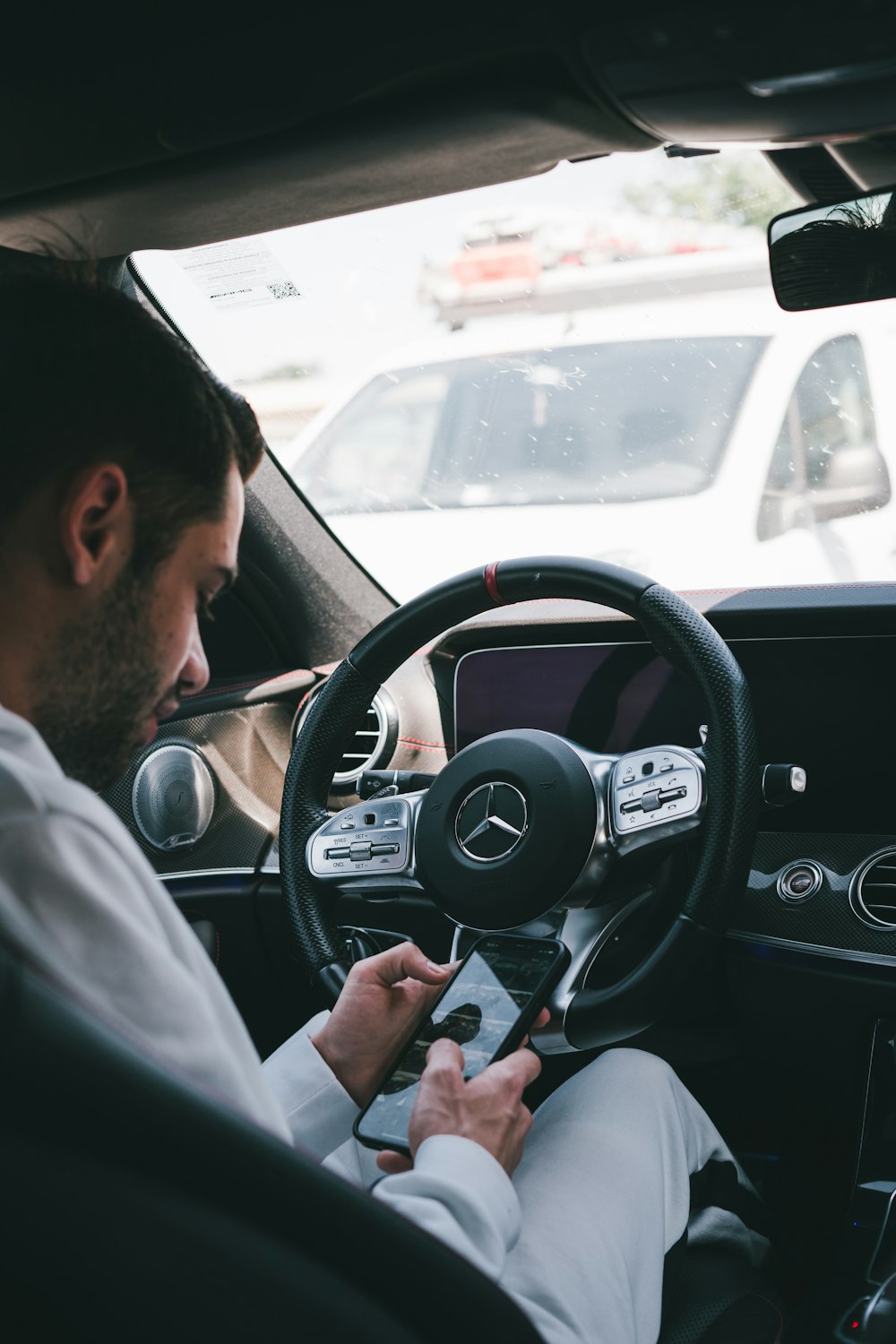 man in white dress shirt driving car during daytime