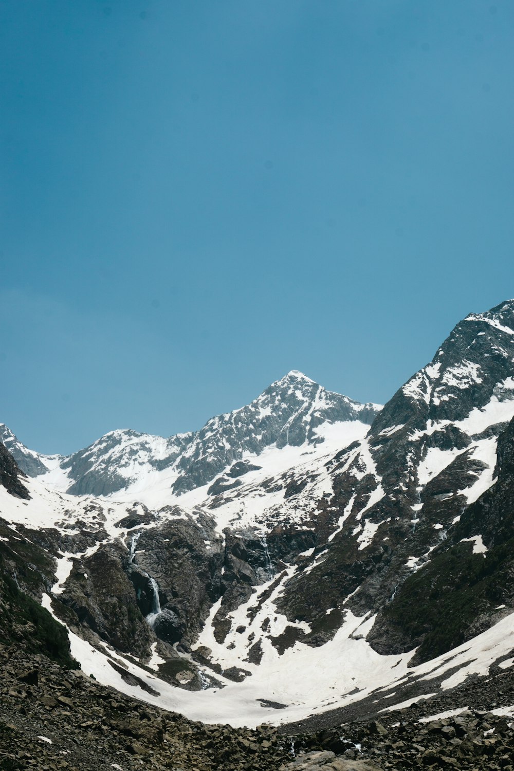 snow covered mountains under blue sky during daytime