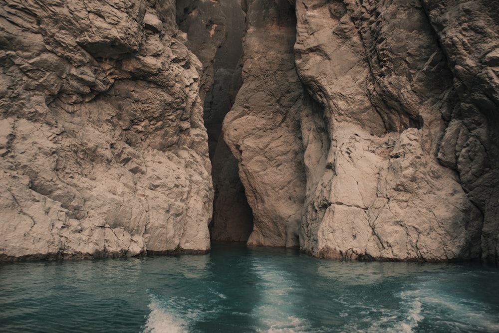 brown rock formation on blue sea during daytime