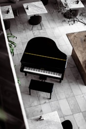 black grand piano on brown wooden floor