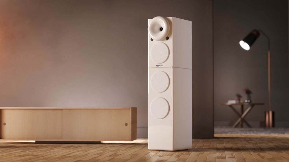 white speaker on brown wooden floor