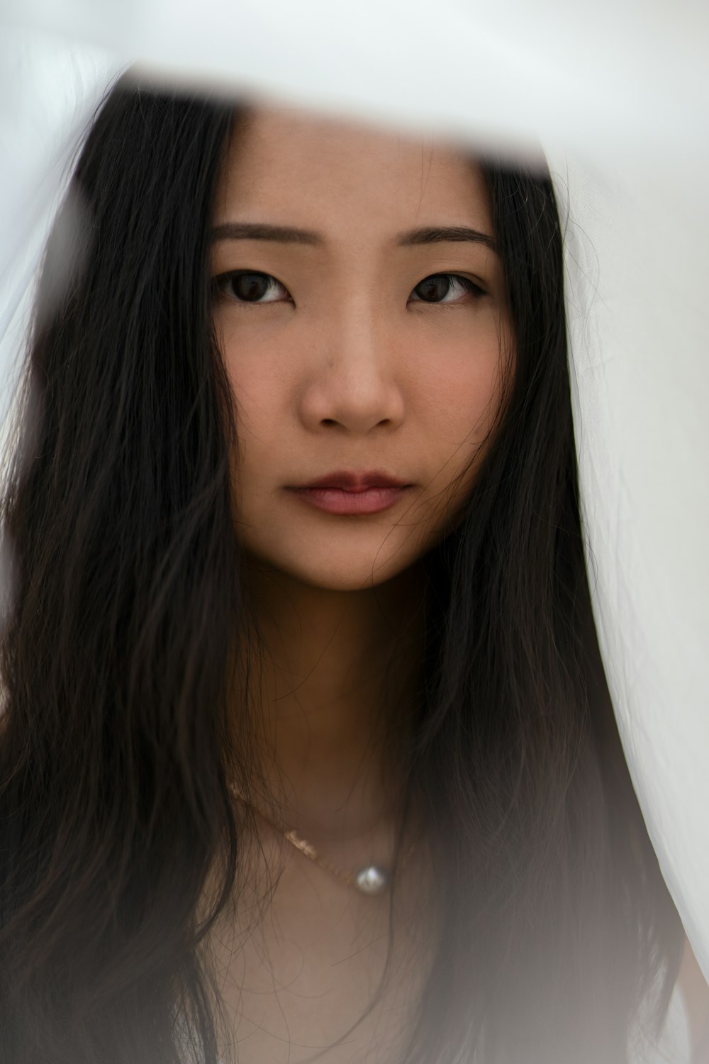 woman in white shirt wearing silver necklace